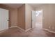 Neutral carpeted bedroom features a white door and baseboards at 5216 Old Mountain Ln, Powder Springs, GA 30127