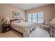 Bedroom with a queen bed, large windows, and decorative furniture at 5216 Old Mountain Ln, Powder Springs, GA 30127