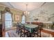 Formal dining room featuring a chandelier, mural wall decor, and draped windows at 5216 Old Mountain Ln, Powder Springs, GA 30127