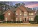 A classic brick home featuring a well-manicured lawn and grand entrance at 5216 Old Mountain Ln, Powder Springs, GA 30127