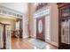 Grand foyer with hardwood floors, decorative front door with leaded glass, and elegant decor at 5216 Old Mountain Ln, Powder Springs, GA 30127