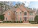 Brick home with a manicured lawn, decorative shrubbery, complemented by a front door with decorative glass at 5216 Old Mountain Ln, Powder Springs, GA 30127