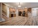 Open kitchen with wood cabinets, black appliances, and hardwood floors at 5216 Old Mountain Ln, Powder Springs, GA 30127