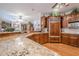 Spacious kitchen featuring granite countertops, custom wood cabinetry and modern appliances at 5216 Old Mountain Ln, Powder Springs, GA 30127