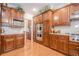 Traditional style kitchen featuring wood cabinets, granite counters, stainless appliances, and hardwood floors at 5216 Old Mountain Ln, Powder Springs, GA 30127