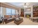 Comfortable living room with a leather sofa, fireplace, and built-in bookshelves at 5216 Old Mountain Ln, Powder Springs, GA 30127