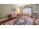 Bright living room with hardwood floors, a decorative rug, and traditional furnishings at 5216 Old Mountain Ln, Powder Springs, GA 30127