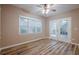 Open living room area with hardwood floors, french doors and lots of natural light at 5216 Old Mountain Ln, Powder Springs, GA 30127