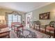 Cozy living room featuring hardwood floors, a decorative rug, and ample natural light at 5216 Old Mountain Ln, Powder Springs, GA 30127