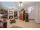 Spacious living room with a fireplace, built-in bookshelves, and staircase access at 5216 Old Mountain Ln, Powder Springs, GA 30127
