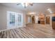 Open-concept living area with hardwood floors connecting to French doors and a partial kitchen at 5216 Old Mountain Ln, Powder Springs, GA 30127