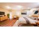 A spacious, staged bedroom is bright and airy and includes hardwood floors, recessed lighting, and comfortable decor at 5430 Glenridge Vw # 1601, Sandy Springs, GA 30342