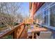 Outdoor patio with wood table and four chairs, partially covered with glass windows at 5430 Glenridge Vw # 1601, Sandy Springs, GA 30342