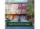 Rear of the house with a two-car garage and back deck; surrounded by mature trees at 5430 Glenridge Vw # 1601, Sandy Springs, GA 30342