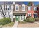 Inviting townhome exterior featuring a green door and landscaping at 1304 Wedgewood Ct, Atlanta, GA 30350