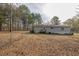 Rear view of mobile home with deck and fenced yard at 1050 Zion Church Rd, Dallas, GA 30157