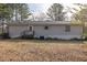 Single-wide mobile home with gray siding, a deck, and a spacious yard at 1050 Zion Church Rd, Dallas, GA 30157