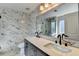 Bathroom featuring a double sink vanity, granite counters, and marble tile walls at 1175 Mercury Dr, Lawrenceville, GA 30045