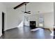 Open living room with dark wood floors, a fireplace, and a door to the outside at 1175 Mercury Dr, Lawrenceville, GA 30045