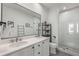 Modern bathroom featuring a double vanity, large mirror, and a glass-enclosed shower with white vertical tiles at 1260 Wright Se Ln, Atlanta, GA 30316