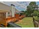 Hot tub, deck, and grassy backyard with fence at 1403 Shiloh Oak Dr, Loganville, GA 30052