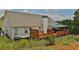 House back view, deck, gazebo, fenced yard with landscaping at 1403 Shiloh Oak Dr, Loganville, GA 30052