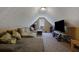 Bonus room with a sectional sofa and large TV at 1403 Shiloh Oak Dr, Loganville, GA 30052