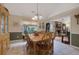 Bright dining room with wood table and chairs, built-in hutch, and view to Gathering room at 1403 Shiloh Oak Dr, Loganville, GA 30052