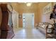 Bright entryway with tile flooring, wooden bench, and grandfather clock at 1403 Shiloh Oak Dr, Loganville, GA 30052