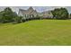 Brick house with a large grassy yard and lush landscaping at 1403 Shiloh Oak Dr, Loganville, GA 30052