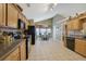 Open kitchen with breakfast nook, wood cabinets, and black appliances at 1403 Shiloh Oak Dr, Loganville, GA 30052