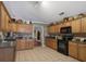 Kitchen boasts wood cabinets, black appliances, and granite countertops at 1403 Shiloh Oak Dr, Loganville, GA 30052