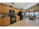 Open kitchen with breakfast nook, wood cabinets and black appliances at 1403 Shiloh Oak Dr, Loganville, GA 30052