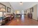 Hardwood floor living room with vaulted ceiling, comfortable seating, and a view to the entryway at 1403 Shiloh Oak Dr, Loganville, GA 30052