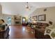 Spacious living room with hardwood floors, a stone fireplace, and ample natural light at 1403 Shiloh Oak Dr, Loganville, GA 30052