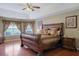 Main bedroom features hardwood floors, large windows, and a sleigh bed at 1403 Shiloh Oak Dr, Loganville, GA 30052