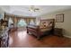 Spacious main bedroom with hardwood floors, large windows, and a sleigh bed at 1403 Shiloh Oak Dr, Loganville, GA 30052