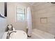 Clean bathroom with a shower/tub combo, neutral tile, and updated vanity at 15 E Georgia Ave, Emerson, GA 30137