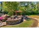 Outdoor space with a stone patio, pergola, and lush landscaping at 27 Lakes Edge Se Dr, Smyrna, GA 30080