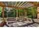 Inviting covered patio featuring swing benches and stone accents for outdoor relaxation and enjoyment at 27 Lakes Edge Se Dr, Smyrna, GA 30080