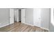 Bedroom with multiple doors, new floors, and neutral paint at 8690 Ashley Way, Douglasville, GA 30134