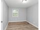 Bedroom with wood-look flooring, light gray walls, and a window at 8690 Ashley Way, Douglasville, GA 30134
