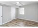 A spacious bedroom with lots of natural light, ceiling fan, and new wood floors at 8690 Ashley Way, Douglasville, GA 30134