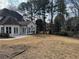 Expansive backyard with a patio area and well-maintained lawn surrounded by mature trees at 9240 Prestwick Club Dr, Duluth, GA 30097