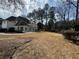 Expansive backyard with a patio area and well-maintained lawn surrounded by mature trees at 9240 Prestwick Club Dr, Duluth, GA 30097