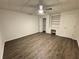 Spacious bedroom with wood floors, ceiling fan, built-in shelving, and closet space at 9240 Prestwick Club Dr, Duluth, GA 30097