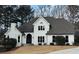 Two-story house with white exterior, dark roof, and landscaping at 9240 Prestwick Club Dr, Duluth, GA 30097