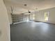 A spacious garage with epoxy floors, windows for natural light, and a garage door at 9240 Prestwick Club Dr, Duluth, GA 30097