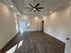 Spacious main bedroom features tray ceilings, modern lighting, and wood flooring at 9240 Prestwick Club Dr, Duluth, GA 30097