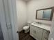 Charming powder room features a white vanity, granite countertops, and a modern mirror at 9240 Prestwick Club Dr, Duluth, GA 30097